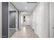 Hallway featuring sleek flooring, white doors and access to a bedroom, showing style and functionality at 24953 N 172Nd Dr, Surprise, AZ 85387