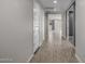 A bright hallway with hardwood floors, showing access to other parts of the home at 24953 N 172Nd Dr, Surprise, AZ 85387