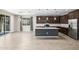 This kitchen features an island with marble countertops and dark wood cabinets at 24953 N 172Nd Dr, Surprise, AZ 85387