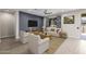 This bright living room features a navy accent wall, neutral furniture and wood-look floors at 24953 N 172Nd Dr, Surprise, AZ 85387