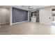This living room has a dark accent wall and wood-look floors at 24953 N 172Nd Dr, Surprise, AZ 85387