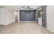 Neutral living room features a dark accent wall, a ceiling fan and wood-look floors at 24953 N 172Nd Dr, Surprise, AZ 85387