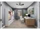 Well-lit home office with built-in shelving, a comfortable chair and a bright window at 24953 N 172Nd Dr, Surprise, AZ 85387