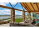 Picturesque outdoor patio featuring stone pillars, comfortable seating, and a scenic view of the lake and mountains at 24953 N 172Nd Dr, Surprise, AZ 85387