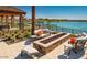 Beautiful patio with stone fire pit overlooking a lake at the community at 24953 N 172Nd Dr, Surprise, AZ 85387