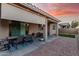 Covered patio with dining set, outdoor seating area, and manicured landscaping at 24953 N 172Nd Dr, Surprise, AZ 85387