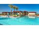 Resort-style pool with lounge chairs, pergolas, and palm trees, offering a relaxing outdoor oasis at 24953 N 172Nd Dr, Surprise, AZ 85387