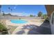 Backyard showcasing a refreshing pool, rock landscaping, and fencing at 2548 E Encanto St, Mesa, AZ 85213