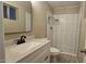 Updated bathroom with a single sink vanity, stylish mirror, and tiled walk-in shower at 2548 E Encanto St, Mesa, AZ 85213