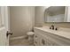 Bathroom with a vanity featuring a sleek black faucet and a modern framed mirror at 2548 E Encanto St, Mesa, AZ 85213