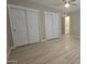 Bedroom featuring two large closets, wood-look floors, and an attached bathroom at 2548 E Encanto St, Mesa, AZ 85213