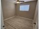 Bedroom featuring wood-look flooring, neutral walls, and a window for natural light at 2548 E Encanto St, Mesa, AZ 85213