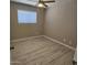 Bedroom featuring wood-look flooring, a ceiling fan, and a window for natural light at 2548 E Encanto St, Mesa, AZ 85213
