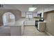 Contemporary kitchen with white cabinets, quartz countertops, and stainless steel appliances at 2548 E Encanto St, Mesa, AZ 85213