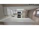 Updated kitchen showcasing white cabinets, quartz countertops, and stainless steel appliances at 2548 E Encanto St, Mesa, AZ 85213