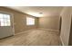 Bright living room with stylish wood-look flooring and a window with natural light at 2548 E Encanto St, Mesa, AZ 85213