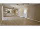 Bright, open layout with wood-look flooring, kitchen access, and a back door at 2548 E Encanto St, Mesa, AZ 85213