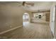Open living space with archway to kitchen, wood-look flooring, and a ceiling fan at 2548 E Encanto St, Mesa, AZ 85213