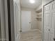 Bright mud room with wood-look tile floor, coat closet, and extra storage shelves at 2548 E Encanto St, Mesa, AZ 85213