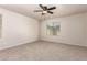 Neutral bedroom features carpeted floors, a ceiling fan and a window at 2640 N 73Rd Gln, Phoenix, AZ 85035