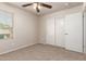 Bright bedroom featuring a ceiling fan, large closet and large window at 2640 N 73Rd Gln, Phoenix, AZ 85035