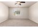 Neutral bedroom features carpeted floors, a ceiling fan and a window at 2640 N 73Rd Gln, Phoenix, AZ 85035