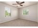 Bright bedroom with two windows offering natural light and plush neutral carpet at 2640 N 73Rd Gln, Phoenix, AZ 85035