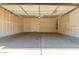 Spacious two-car garage featuring high ceilings and concrete floor at 2640 N 73Rd Gln, Phoenix, AZ 85035