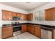 Kitchen featuring wood cabinets, stainless steel appliances, and granite countertops at 2640 N 73Rd Gln, Phoenix, AZ 85035