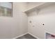 Bright laundry room featuring built-in shelf and hookups at 2640 N 73Rd Gln, Phoenix, AZ 85035