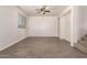 Open living room with a ceiling fan, plank flooring, and ample natural light at 2640 N 73Rd Gln, Phoenix, AZ 85035