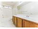 Bright bathroom featuring a long vanity with tile floors and a combined tub and shower at 2783 E Mineral Park Rd, San Tan Valley, AZ 85143