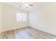 This bedroom has wood floors, a window with blinds and a ceiling fan with a light at 2783 E Mineral Park Rd, San Tan Valley, AZ 85143