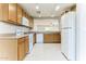 Bright kitchen with wood cabinets, tile flooring, and white appliances at 2783 E Mineral Park Rd, San Tan Valley, AZ 85143