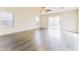 Spacious living room featuring wood-look floors, a ceiling fan, and views of the backyard at 2783 E Mineral Park Rd, San Tan Valley, AZ 85143