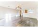 Large, open living space with wood-look flooring and a view of the kitchen at 2783 E Mineral Park Rd, San Tan Valley, AZ 85143