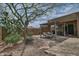 Relaxing backyard patio with mature landscaping, stone walkway, and shaded pergola at 3522 W Rushmore Dr, Anthem, AZ 85086