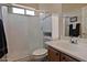 Bathroom with tiled shower and storage cabinet next to the toilet at 3522 W Rushmore Dr, Anthem, AZ 85086