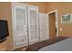 Bedroom with shuttered doors and a view to an additional room at 3522 W Rushmore Dr, Anthem, AZ 85086