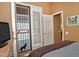 Bedroom with shuttered doors leading to outdoor covered patio area and pool at 3522 W Rushmore Dr, Anthem, AZ 85086
