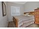This cozy bedroom features a wooden bed frame, a window with shutters, and an abundance of natural light at 3522 W Rushmore Dr, Anthem, AZ 85086