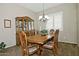 Elegant dining room featuring a wood table, china cabinet, and large window with shutters at 3522 W Rushmore Dr, Anthem, AZ 85086