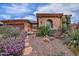 Charming single-story home boasts a well-manicured desert landscape with various cacti and succulents at 3522 W Rushmore Dr, Anthem, AZ 85086