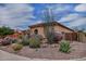 Charming single-story home boasts a well-manicured desert landscape with various cacti and succulents at 3522 W Rushmore Dr, Anthem, AZ 85086