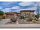 Charming single-story home boasts a well-manicured desert landscape with colorful flowering bushes at 3522 W Rushmore Dr, Anthem, AZ 85086
