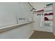 Organized walk-in closet with shelving, hanging rods, and a decorative sign at 3522 W Rushmore Dr, Anthem, AZ 85086