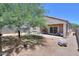 View of the backyard with enclosed patio and mature landscaping at 36467 W Pampoloma Ave, Maricopa, AZ 85138