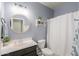 Well-lit bathroom featuring a vanity with sink, a mirror, a toilet, and a shower tub at 36467 W Pampoloma Ave, Maricopa, AZ 85138