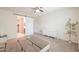 Bright bedroom with neutral carpet, white dresser, and barn door to bathroom at 36467 W Pampoloma Ave, Maricopa, AZ 85138