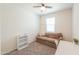 Bright bedroom with a ceiling fan, a sofa, and a desk. Natural light illuminates the space at 36467 W Pampoloma Ave, Maricopa, AZ 85138